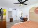 Charming bedroom with a modern ceiling fan, barn door, and en-suite bathroom at 1421 Pine Tree Dr, Edgewater, FL 32132