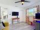 Bright bedroom with a ceiling fan, large windows, with an additional tv-viewing area and closet at 1421 Pine Tree Dr, Edgewater, FL 32132
