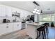 Open concept kitchen featuring stainless steel appliances, white cabinets, and an island with seating at 1421 Pine Tree Dr, Edgewater, FL 32132