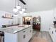 Spacious kitchen with a large island, stylish lighting, and an adjacent dining area and living room at 1421 Pine Tree Dr, Edgewater, FL 32132