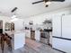 Well-lit kitchen featuring stainless appliances, a center island with bar stool seating, and white cabinetry at 1421 Pine Tree Dr, Edgewater, FL 32132