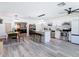Bright, open kitchen with stainless steel appliances, white cabinets, and an island with granite countertops at 1421 Pine Tree Dr, Edgewater, FL 32132