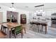 Kitchen and Dining area showing stainless appliances, white cabinets, and breakfast bar with stools at 1421 Pine Tree Dr, Edgewater, FL 32132