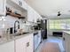 Modern kitchen features stainless steel appliances, granite counters, subway tile backsplash, and a window at 1421 Pine Tree Dr, Edgewater, FL 32132