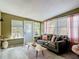 Cozy sunroom with large windows, natural light, seating, and stylish decor for relaxation at 1421 Pine Tree Dr, Edgewater, FL 32132