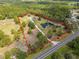 Expansive property with mature trees, a large pond, and a long driveway at 156 S State Road 415, New Smyrna Beach, FL 32168
