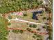 Large property with a house, guest house, pool, pond, and mature trees at 156 S State Road 415, New Smyrna Beach, FL 32168