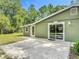 Exterior view of the building showing patio with green siding at 156 S State Road 415, New Smyrna Beach, FL 32168