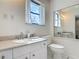 Bright bathroom featuring a large mirror and a toilet with a dual flush system at 156 S State Road 415, New Smyrna Beach, FL 32168