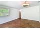 Spacious bedroom featuring wood-look tile flooring and a modern ceiling fan fixture at 156 S State Road 415, New Smyrna Beach, FL 32168