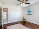 Hardwood floors, ceiling fan, and natural light accent this comfortable bedroom at 156 S State Road 415, New Smyrna Beach, FL 32168