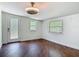 This room has hardwood floors, natural light from two windows, and a secure backdoor at 156 S State Road 415, New Smyrna Beach, FL 32168
