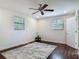 Cozy bedroom featuring a ceiling fan, hardwood floors and natural light at 156 S State Road 415, New Smyrna Beach, FL 32168