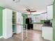 Bright kitchen features white cabinets, modern appliances, a breakfast bar and views of the outdoors at 156 S State Road 415, New Smyrna Beach, FL 32168