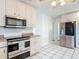 A bright kitchen featuring stainless steel appliances and white cabinetry at 156 S State Road 415, New Smyrna Beach, FL 32168