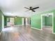 Open layout in the living room with ceiling fans and wood-look flooring at 156 S State Road 415, New Smyrna Beach, FL 32168