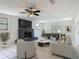 Bright living room featuring a fireplace, ceiling fan, and dining area at 156 S State Road 415, New Smyrna Beach, FL 32168
