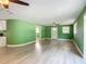 Bright open floorplan showcasing wood-look flooring and a ceiling fan at 156 S State Road 415, New Smyrna Beach, FL 32168