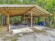 Outbuilding with concrete floor, corrugated metal roof, and storage area at 156 S State Road 415, New Smyrna Beach, FL 32168
