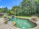 Resort-style pool featuring lush landscaping and a tranquil waterfall at 156 S State Road 415, New Smyrna Beach, FL 32168