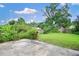 Expansive backyard with a lush lawn, mature trees, and a privacy fence at 1903 Willow Oak Dr, Edgewater, FL 32141