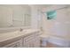 Bathroom featuring tub, toilet, vanity with sink, and window at 1903 Willow Oak Dr, Edgewater, FL 32141