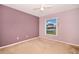 Bedroom featuring neutral carpet and a window providing natural light and neighborhood views at 1903 Willow Oak Dr, Edgewater, FL 32141