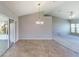 Dining area boasts tile floors, chandelier lighting, and sliding door access to outdoor patio at 1903 Willow Oak Dr, Edgewater, FL 32141