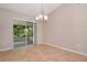 Open dining area with sliding glass doors to a screened lanai at 1903 Willow Oak Dr, Edgewater, FL 32141