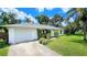 Charming single-story home with a well-maintained lawn and mature trees at 1903 Willow Oak Dr, Edgewater, FL 32141