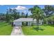 Well-kept single-story home with mature landscaping, a spacious driveway, and an attached garage at 1903 Willow Oak Dr, Edgewater, FL 32141