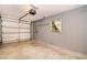 Spacious garage featuring an automatic door opener and a small window at 1903 Willow Oak Dr, Edgewater, FL 32141