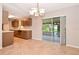 Kitchen with a sliding glass door to a screened lanai and brown cabinetry at 1903 Willow Oak Dr, Edgewater, FL 32141