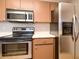 Kitchen area featuring stainless steel appliances, oven, microwave, and refrigerator at 1903 Willow Oak Dr, Edgewater, FL 32141