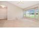 Bright and airy living area with large windows offering natural light and neutral-toned carpet at 1903 Willow Oak Dr, Edgewater, FL 32141