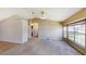 Open living room with high ceilings, large windows, and neutral carpet at 1903 Willow Oak Dr, Edgewater, FL 32141