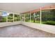 Enclosed porch with tile flooring, screens, and views of the backyard at 1903 Willow Oak Dr, Edgewater, FL 32141