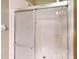 Shower with sliding glass door and white tiled walls and floor at 1903 Willow Oak Dr, Edgewater, FL 32141