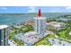 Coastal aerial view featuring a modern condominium, private parking, and scenic waterways at 2 Oceans West Blvd # 206, Daytona Beach Shores, FL 32118