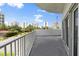This balcony showcases city views in the distance and has a modern white railing with a concrete floor at 2 Oceans West Blvd # 206, Daytona Beach Shores, FL 32118