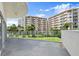 Large balcony showcasing lush landscaping and exterior of building with multiple levels and balconies at 2 Oceans West Blvd # 206, Daytona Beach Shores, FL 32118