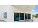 Private balcony featuring sliding glass doors looking into the house, and views of palm trees at 2 Oceans West Blvd # 206, Daytona Beach Shores, FL 32118