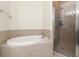 Beautiful bathroom featuring a soaking tub and a glass enclosed walk-in shower at 2 Oceans West Blvd # 206, Daytona Beach Shores, FL 32118