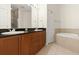 Bathroom featuring double sinks, granite countertop, and bathtub at 2 Oceans West Blvd # 206, Daytona Beach Shores, FL 32118
