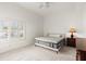 Simple bedroom featuring a comfortable bed, shuttered window, and classic decor at 2 Oceans West Blvd # 206, Daytona Beach Shores, FL 32118