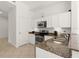Well-lit kitchen with stainless steel appliances and granite countertops, showcasing modern design at 2 Oceans West Blvd # 206, Daytona Beach Shores, FL 32118