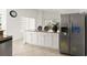 Charming kitchen island with granite countertop and stainless steel refrigerator with decor at 2 Oceans West Blvd # 206, Daytona Beach Shores, FL 32118