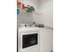 Clean laundry room featuring modern washer and dryer and wire rack for extra storage at 2 Oceans West Blvd # 206, Daytona Beach Shores, FL 32118