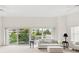 Bright living room with floor to ceiling windows and a large balcony overlooking lush green landscaping at 2 Oceans West Blvd # 206, Daytona Beach Shores, FL 32118