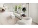Spacious living room featuring a white couch and chairs, with windows and balcony access providing great views at 2 Oceans West Blvd # 206, Daytona Beach Shores, FL 32118